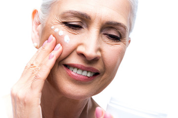 Wall Mural - senior woman applying cream