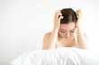 © Nusara - Asian beauty woman have a headache in white bedroom after wake up