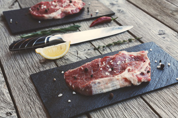 Sticker - Raw beef steak on dark wooden table background