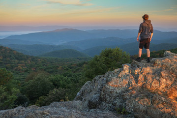 hiker at bearfence mountain in shenandoah national park, virginia