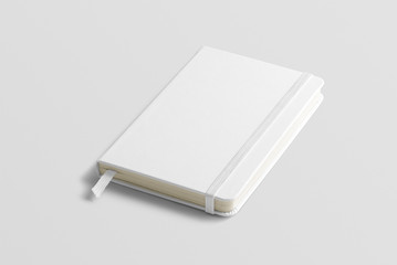 blank photorealistic notebook mockup on light grey background, front view.