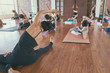 © Somkiat - Group women asian doing stretching yoga hot exercises with instructor in studio