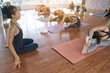 © Somkiat - Group women asian doing stretching yoga hot exercises with instructor in studio