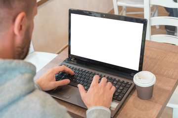 Man work on laptop computer with isolated blank screen for web site presentation mockup.