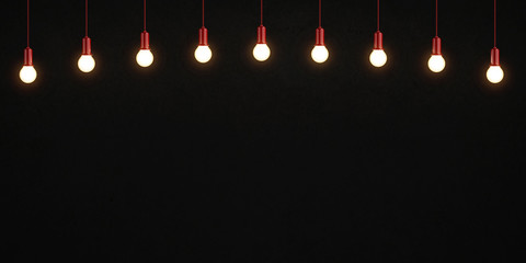 Wall Mural - Glowing light bulbs on dark concrete background. 3D rendering