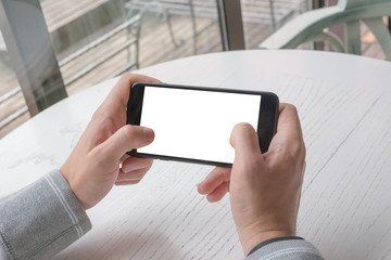 Poster - Playing game on smart phone. Closeup view. Mobile phone with isolated screen for app promotion. Horizontal position.
