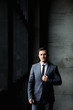 © Gennady Danilkin - Handsome caucasian businessman dressed in the suit near the window in the loft interior studio
