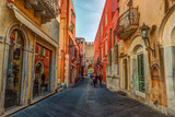 Fototapeta  - Old street in Taormina, Sicily, Italy. Architecture with archs and old pavement.