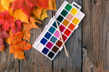 Wall Mural - autumn maple leaves on rustic table