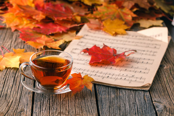 Wall Mural - Fall background with maple leaves on wood table