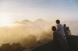 © Alexander Grabchilev/Stocksy - young couple watching sunrise in mountains