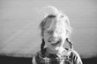 © Meaghan Curry Photography/Stocksy - portrait of a little girl with a big smile as her hair blows in the wind