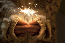 Close up shot of hands holding sparklers