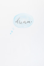 The Word "dream" In Calligraphy On A Watercolor Thinking Bubble 