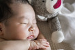 © yuko hirao/Stocksy - Close up of an Asian newborn baby, sleeping