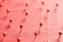 Red Pins Connected With Threads Creating A Network