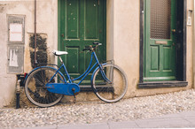 View On Blue Bicycle Parked Near Green Doors