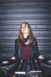 © Danil Nevsky/Stocksy - Portrait of attractive young female DJ at DJ desk