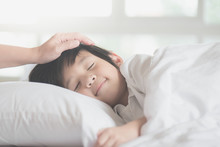Asian Child Sleeping On White Bed