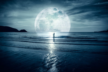 super moon. colorful sky with cloud and bright full moon over seascape.