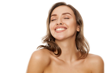 Portrait of beautiful young satisfied woman on white background