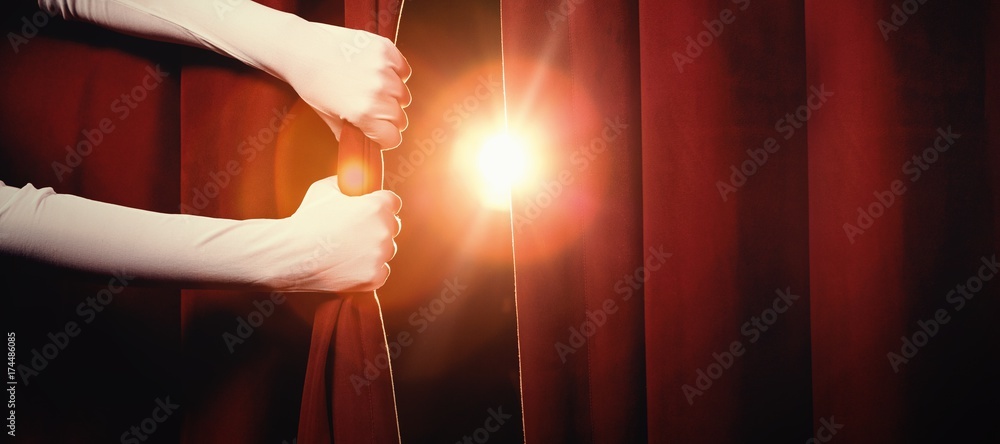 Cropped hands holding curtain at stage - obrazy, fototapety, plakaty 