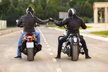 Two Bikers Ot Motocycles Handshaking With Knuckle On Road