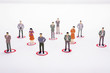© Wisiel - Miniature business people in conection scheme over white backdrop or background.