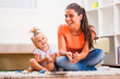 © djoronimo - Mother and daughter in their home. They are playing with plasticine.