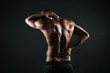 © Drobot Dean - Back view of young african sports man feeling pain in his back