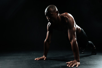 Wall Mural - Portrait of youg afro american sports man doing pushup exercise