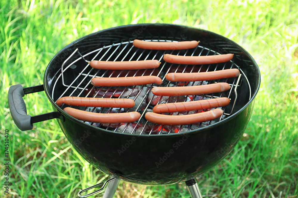 Sausages on barbecue grill outdoors