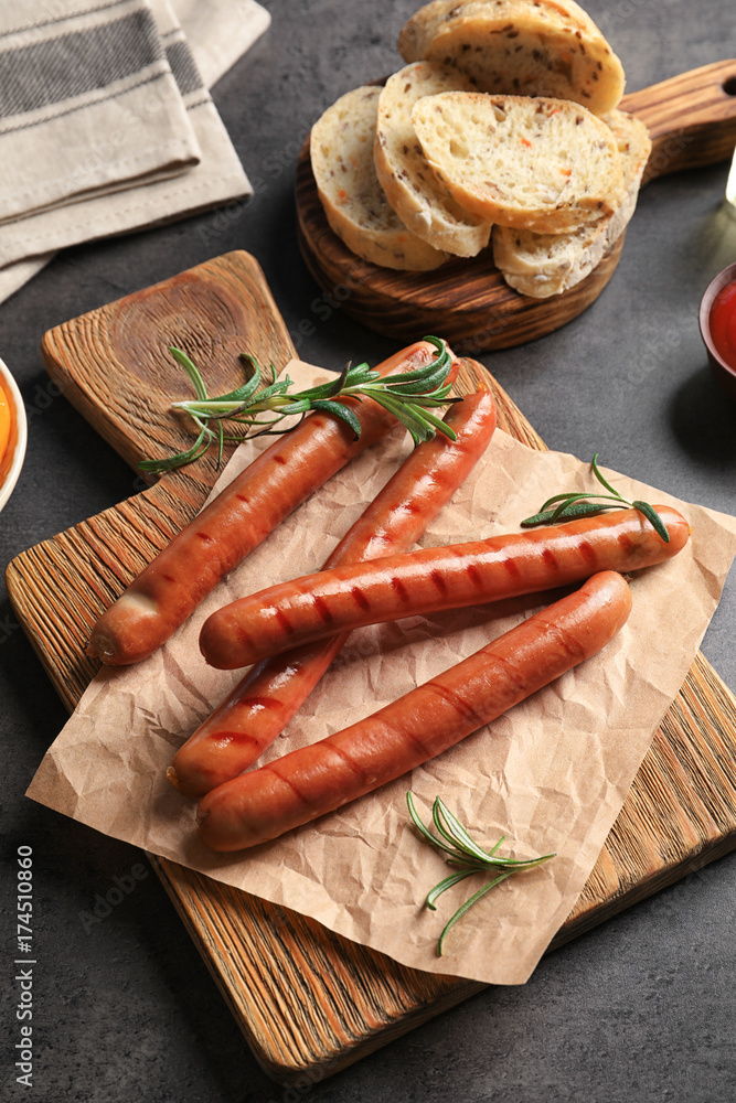 Composition with grilled sausages on kitchen table