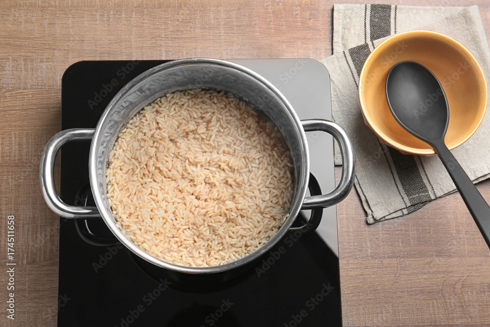 Saucepan with brown rice on stove