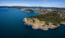 Aerial Panoramic Landscape View Of A Beautiful Rocky Shore On Pacific Coast. Taken In Saxe Point Park, Victoria, Vancouver Island, British Columbia, Canada.