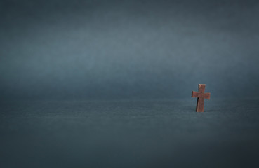 Wall Mural - Wooden cross on a blue background.