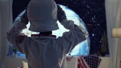 astronaut in apartment with view of planet earth getting ready for a mission