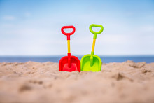 Plastic Toy Shovels On The Beach