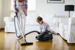 © Nasos Zovoilis/Stocksy - 1 year old boy playing with a vacum cleaner