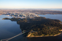 Beautiful Aerial View Of Lions Gate Bridge, Stanley Park And Vancouver Downtown, British Columbia, Canada, During A Bright Spring Sunset.
