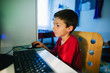 © BONNINSTUDIO/Stocksy - Side view of a little boy studying on computer at home.