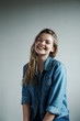 © Brent Hill/Stocksy - Portrait of a young woman laughing