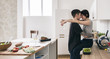 © Danil Nevsky/Stocksy - Young couple hugging in modern kitchen