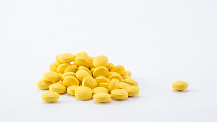 yellow tablets stack on white background