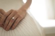 © Wavebreak Media - Mid-section of bride wearing wedding ring