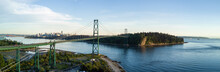 Aerial Panoramic View Of Lions Gate Bridge, Stanley Park And Downtown City In The Background. Taken In Vancouver, British Columbia, Canada.