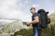 © Fredy Thürig - Hiker looks for the right way with the help of a map