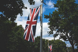 Fototapeta Londyn - Flag of England in sunny day at London city