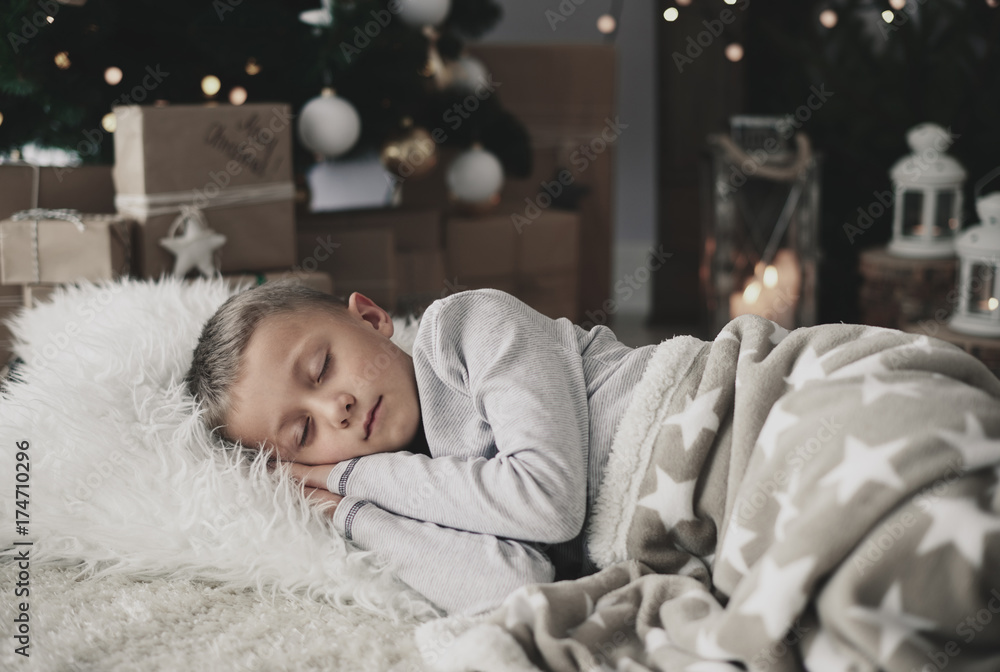 Cute boy sleeping on rug Stock Photo | Adobe Stock
