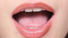 Close Up View Of Female Mouth Which Smiling And Saying I Love You